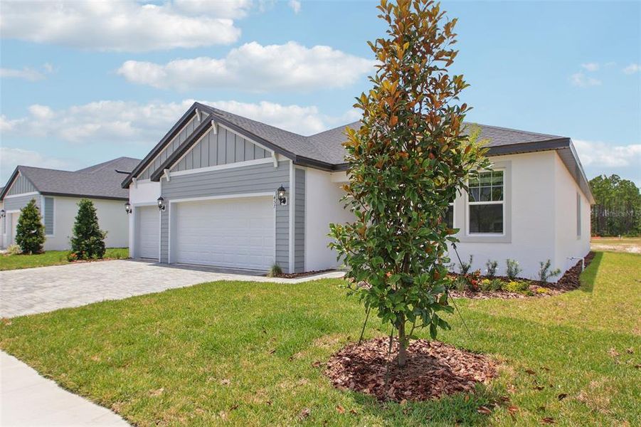 Front exterior of a new home in Ridgehaven - Reserve Series, Ormond Beach, FL, highlighting curb appeal (Image 19).