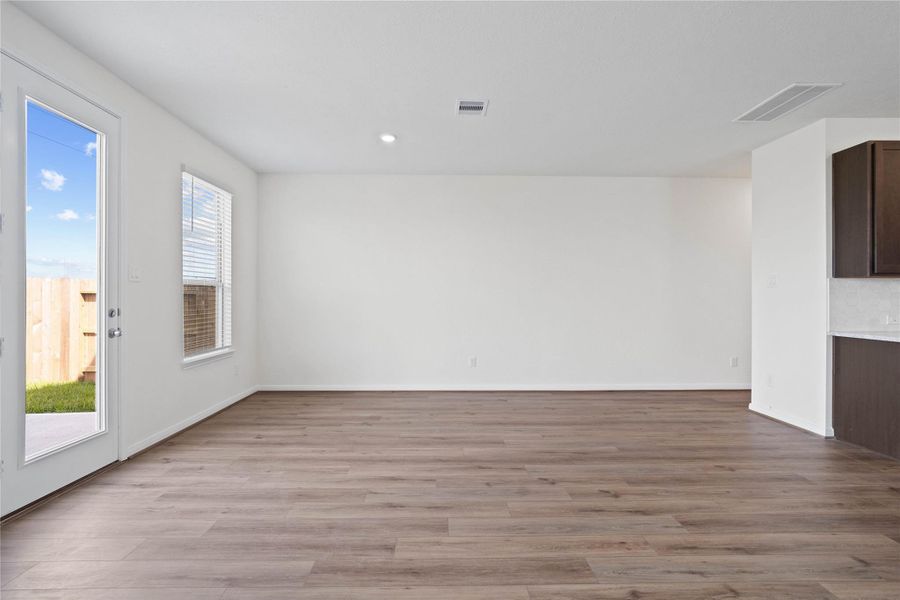 Start your day with a warm cup of coffee and quality time in this charming dining area! Highlights include a large window with blinds, custom neutral paint, vinyl plank flooring, recessed lighting, high ceilings, and a convenient door leading to the rear patio and backyard. Start your day with a warm cup of coffee and quality time in this charming dining area! Highlights include a large window with blinds, custom neutral paint, vinyl plank flooring, recessed lighting, high ceilings, and a convenient door leading to the rear patio and backyard.