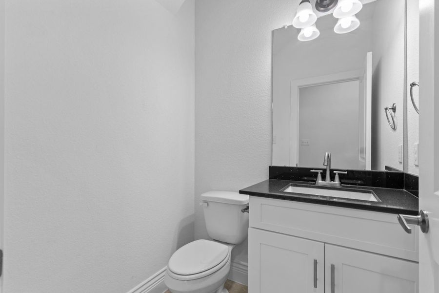 The guest half bathroom shines with a beautiful quartz countertop and a deep undermount sink for a sleek, modern touch. The guest half bathroom shines with a beautiful quartz countertop and a deep undermount sink for a sleek, modern touch.