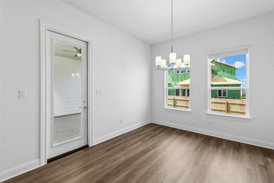 A streamlined dining area features durable wood flooring and abundant natural light.