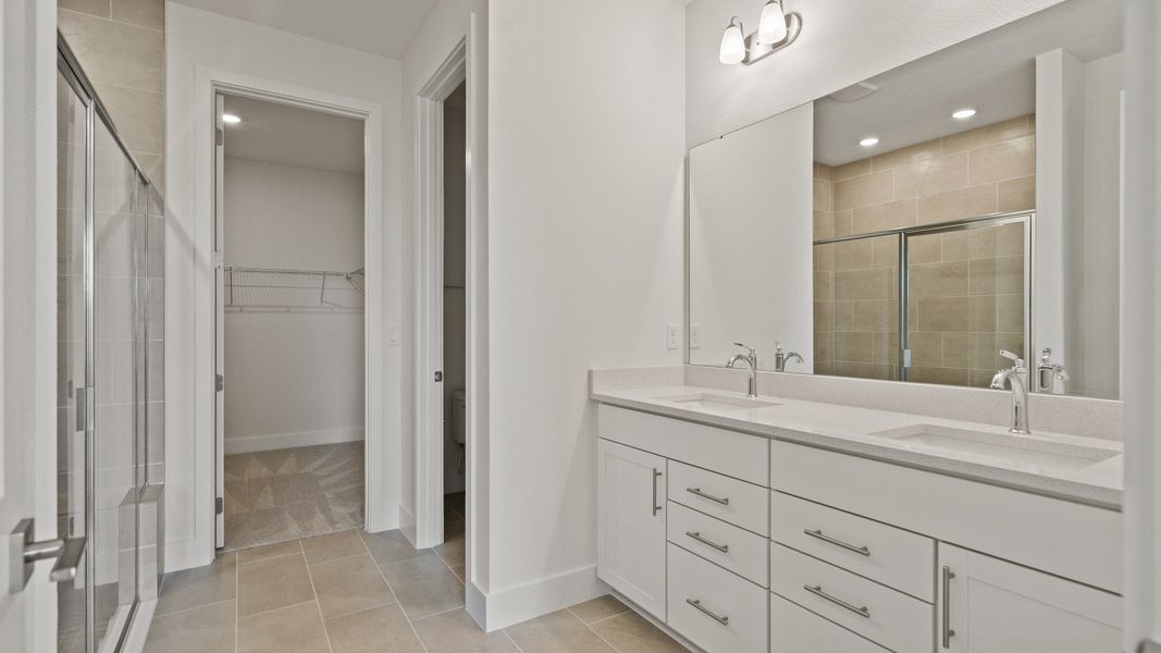 Primary En Suite Bath and Spacious Walk-in Closet in the Buttonwood Floor Plan by DRB Homes Ardisia Park in New Smyrna Beach