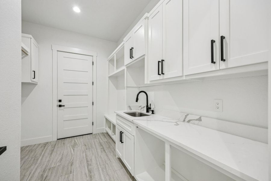 This laundry and mud room has everything you need! Additional cabinets for storage plus a counter to fold clothes or be a catchall! You even have the best spot to store shoes or backpacks This laundry and mud room has everything you need! Additional cabinets for storage plus a counter to fold clothes or be a catchall! You even have the best spot to store shoes or backpacks