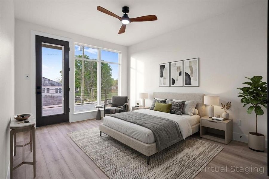 This bedroom features abundant natural light from expansive windows and a glass-paneled door This bedroom features abundant natural light from expansive windows and a glass-paneled door