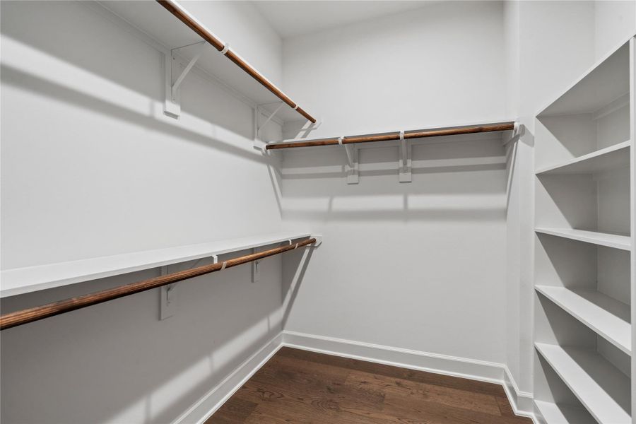One of the home’s two generous walk-in closets, featuring built-in shelving to make the most of the space.