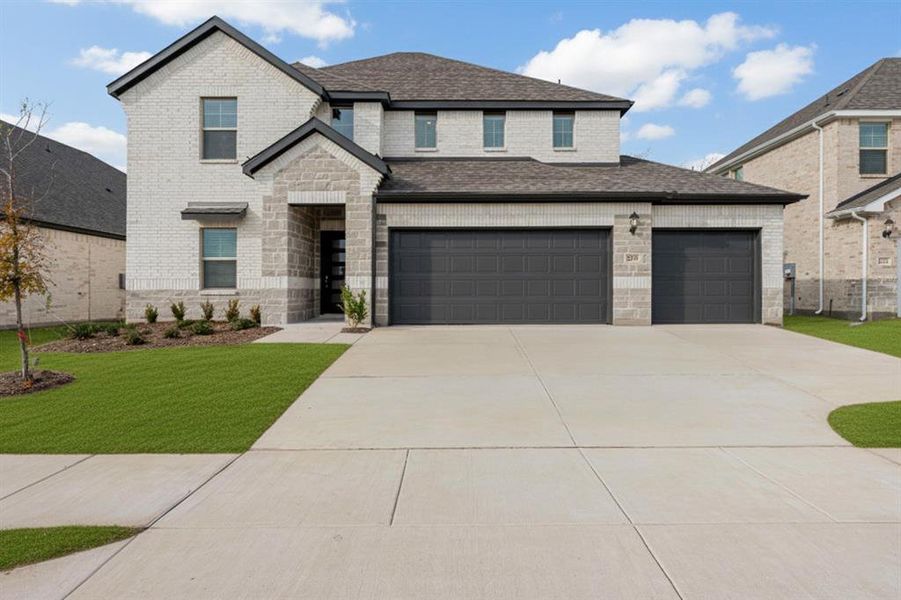 View of front of property with driveway, a front lawn, and brick siding View of front of property with driveway, a front lawn, and brick siding