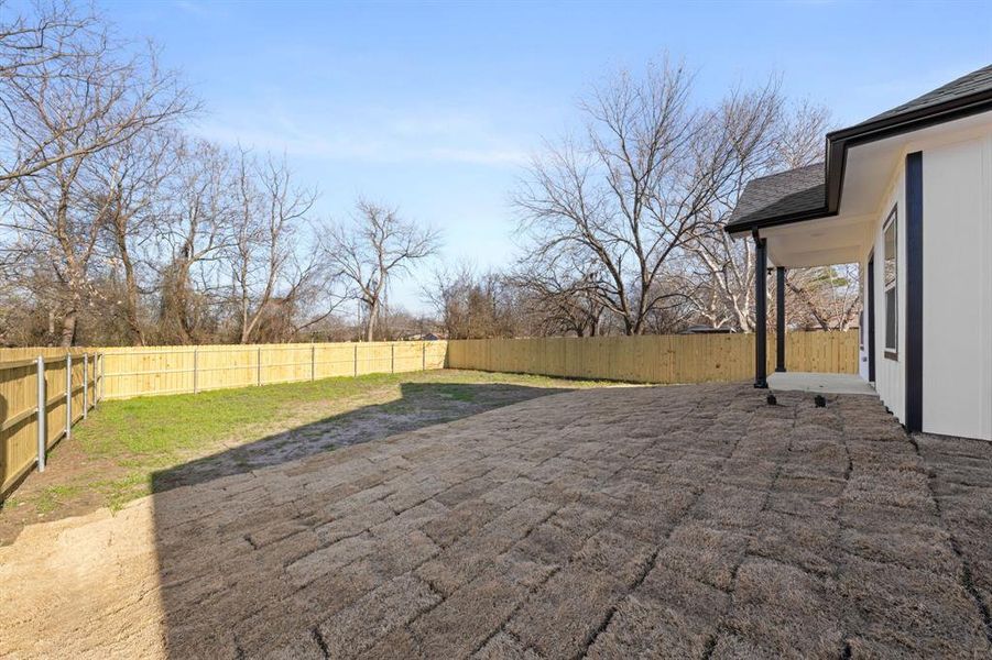 Fenced backyard featuring a patio