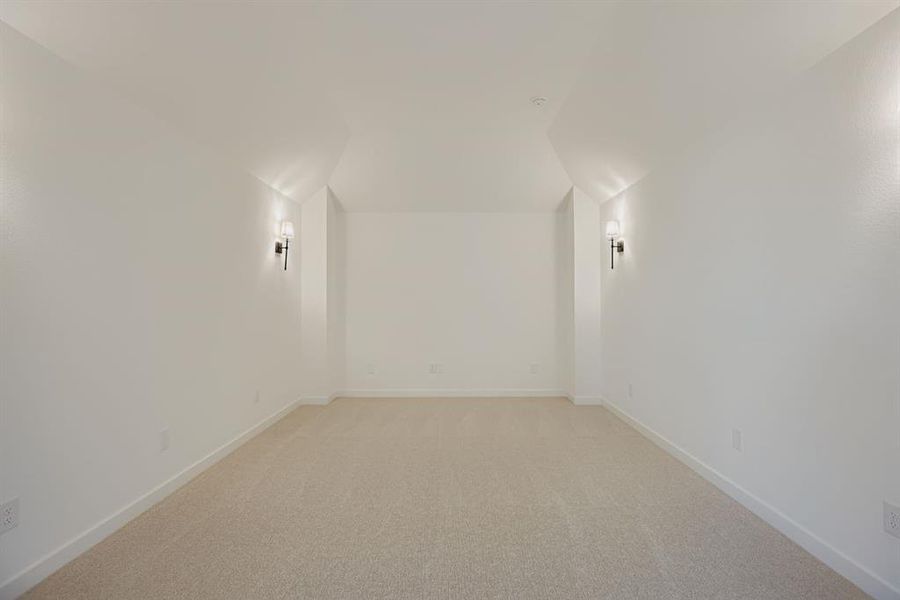 Additional living space with light carpet and baseboards Additional living space with light carpet and baseboards