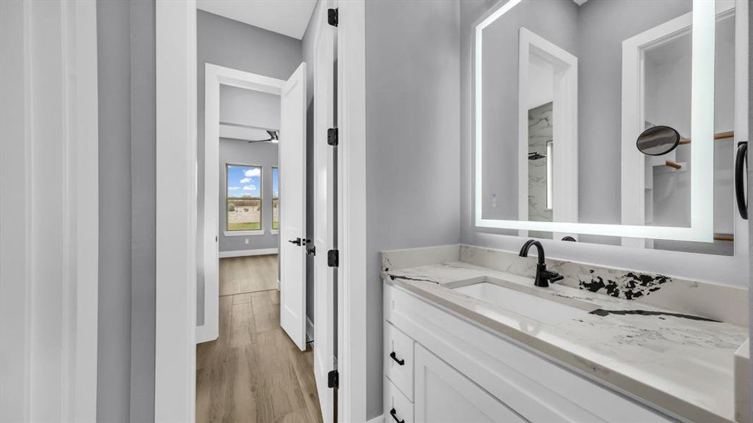 Bathroom featuring vanity and light wood-style floors