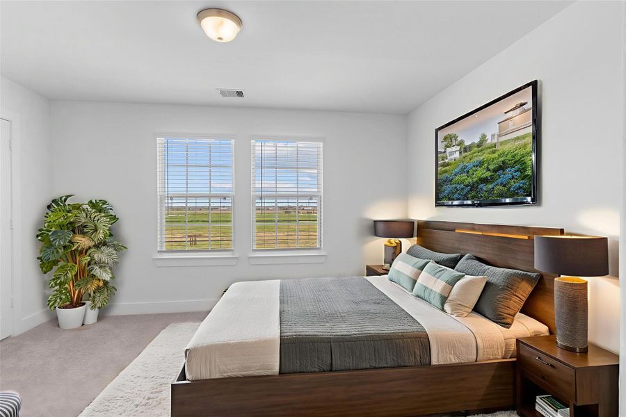 Spacious secondary bedroom with large windows and neutral tones, ready for your personal touch. *Virtually Staged*