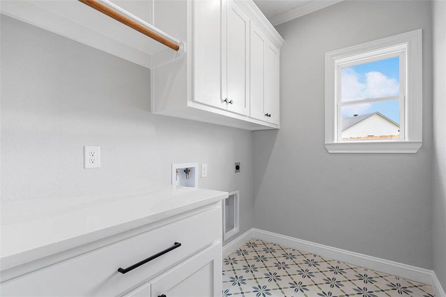 Washroom featuring cabinet space, hookup for a washing machine, electric dryer hookup, and ornamental molding Washroom featuring cabinet space, hookup for a washing machine, electric dryer hookup, and ornamental molding