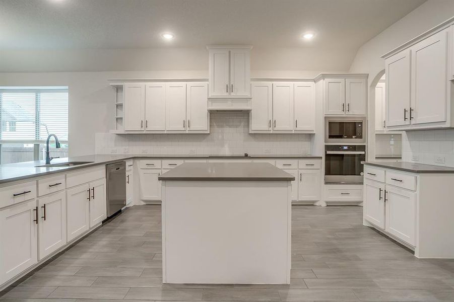 Large open kitchen with prep island and plenty of room for bar stool seating.