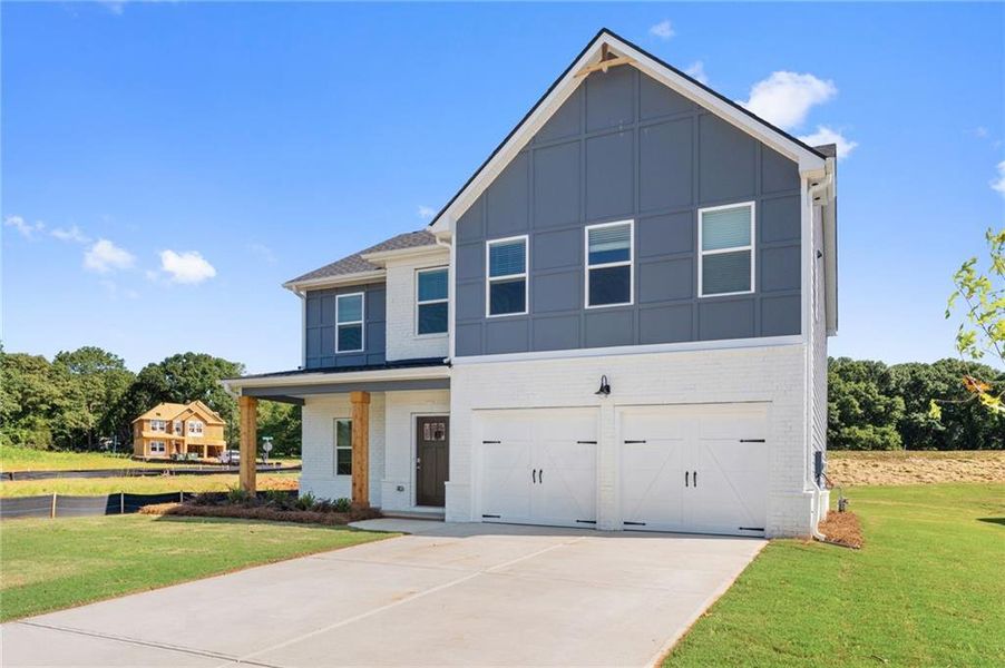 Front exterior of a new home in Conner Springs, Social Circle, GA, highlighting curb appeal (Image 1). Front exterior of a new home in Conner Springs, Social Circle, GA, highlighting curb appeal (Image 1).