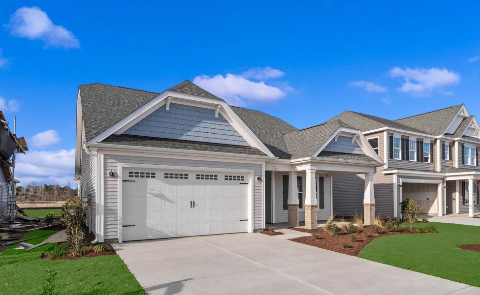 Front exterior of a new home in Traditions at Carolina Forest, Myrtle Beach, SC, highlighting curb appeal (Image 2). Front exterior of a new home in Traditions at Carolina Forest, Myrtle Beach, SC, highlighting curb appeal (Image 2).