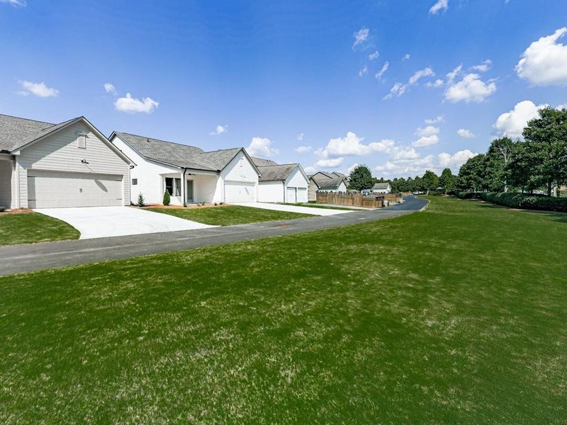 Front exterior of a new home in , Holly Springs, GA, highlighting curb appeal (Image 22). Front exterior of a new home in , Holly Springs, GA, highlighting curb appeal (Image 22).