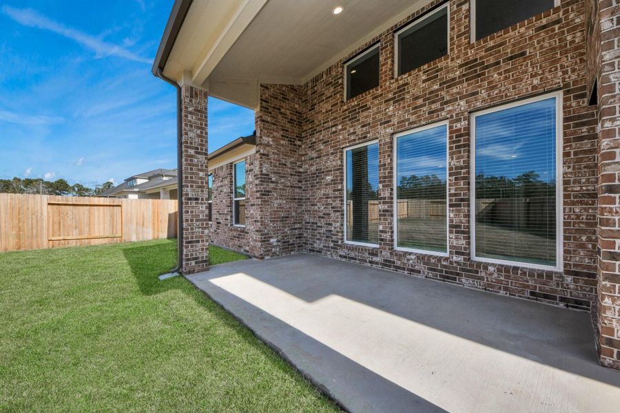 Experience outdoor living at its finest on this expansive covered patio, thoughtfully designed for BBQs and delightful outdoor dining.