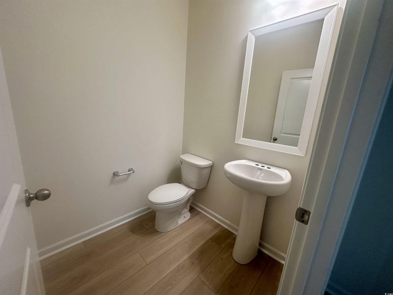 Bathroom with wood finished floors and baseboards Bathroom with wood finished floors and baseboards