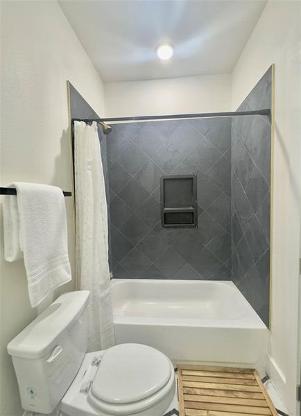 Bathroom with toilet and shower / tub combo