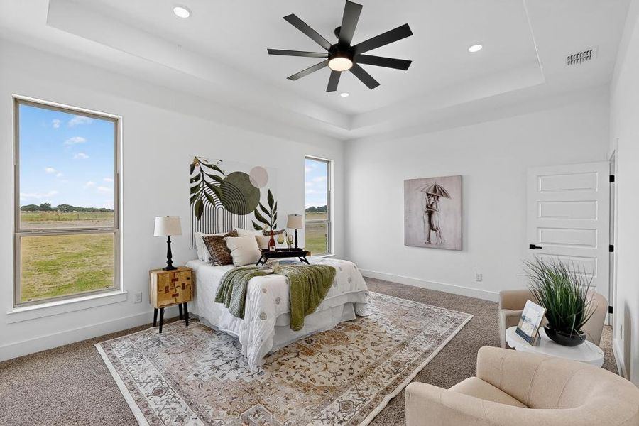 Carpeted bedroom featuring a tray ceiling, recessed lighting, and a ceiling fan