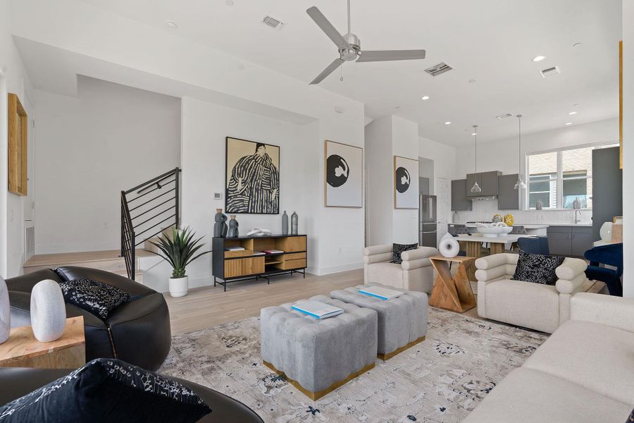 Living room with ceiling fan, light wood-type flooring, and recessed lighting