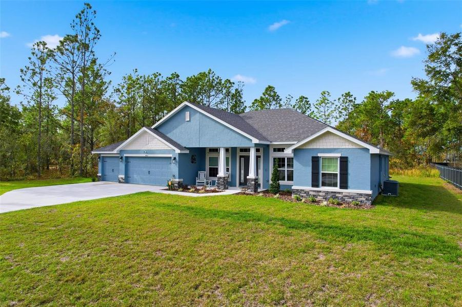 Front exterior of a new home in Royal Highlands, Weeki Wachee, FL, highlighting curb appeal (Image 27).
