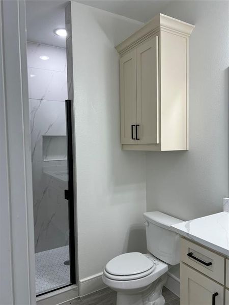 Full bathroom featuring vanity and a marble finish shower