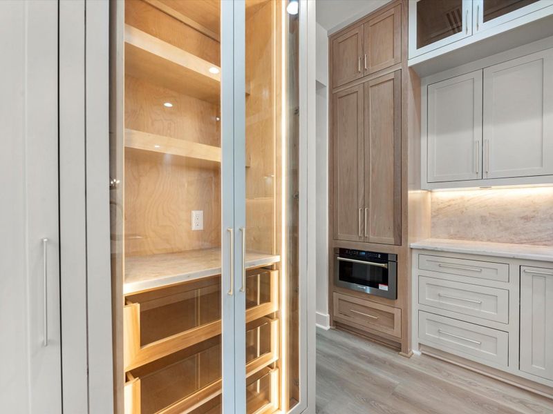 You'll find custom cabinetry throughout, but the details here are; white oak cabinetry, glass face cabinets, luxury appliances, and much much more.