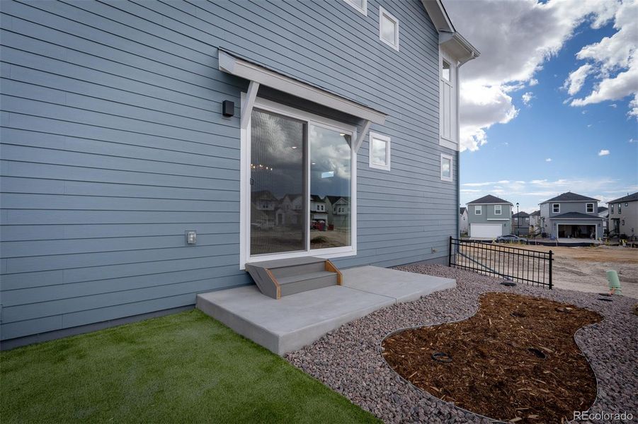 Exterior details and patio area of a home in Revel Crossing at Wolf Ranch – The Ascent Collection, Colorado Springs (Image 1).