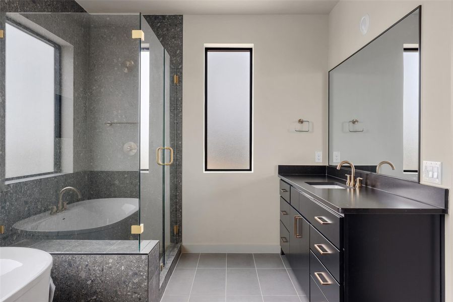 Bathroom featuring vanity, light tile patterned floors, a garden tub, a shower stall, and healthy amount of natural light