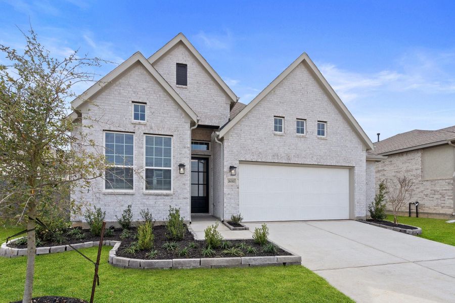 Front exterior of a new home in The Woodlands Hills, Willis, TX, highlighting curb appeal (Image 18).