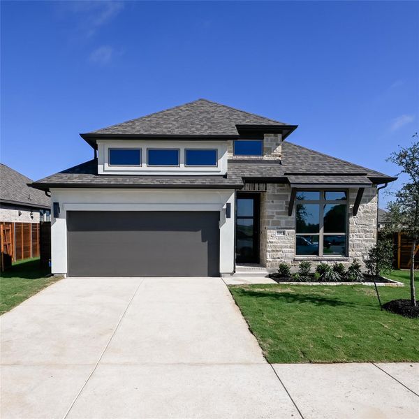 Front exterior of a new home in Juniper Springs, Lockhart, TX, highlighting curb appeal (Image 2). Front exterior of a new home in Juniper Springs, Lockhart, TX, highlighting curb appeal (Image 2).