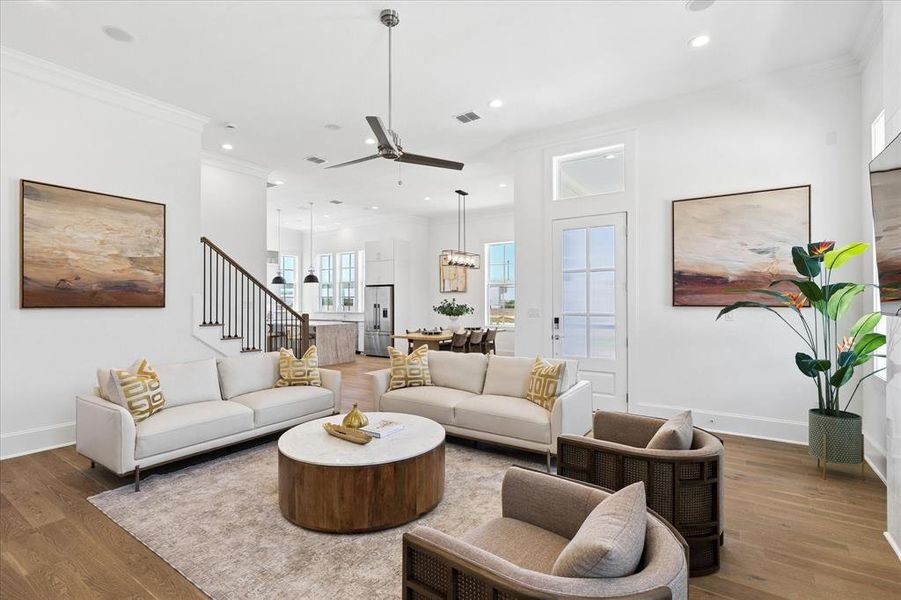 Spacious living area featuring wood-finish flooring, recessed lighting, and a modern ceiling fan