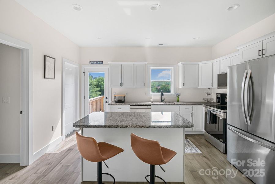 Bright kitchen with island and bar seats