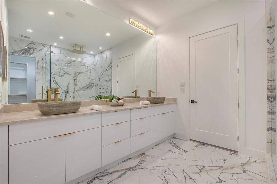 Bathroom with vanity and a shower with door