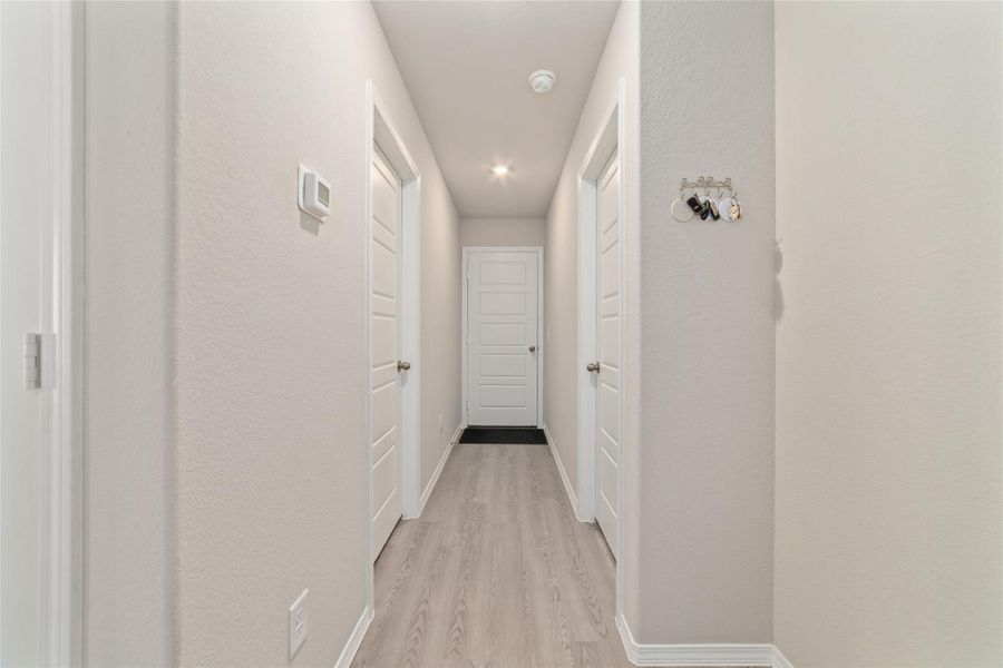 Bright hallway with high ceilings and recessed lighting, offering a clean, open feel that flows effortlessly to the rest of the home.