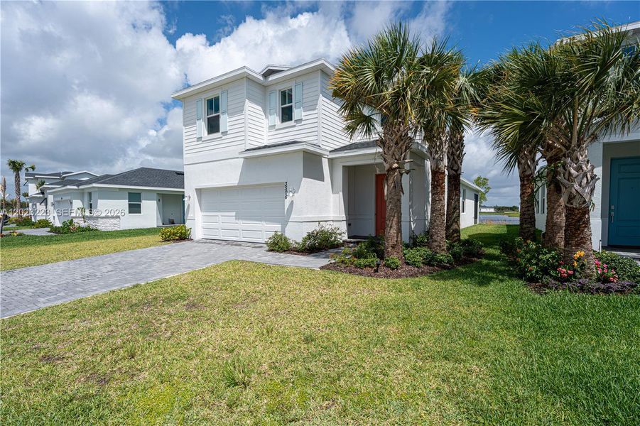 Front exterior of a new home in Seagrove, Fort Pierce, FL, highlighting curb appeal (Image 23). Front exterior of a new home in Seagrove, Fort Pierce, FL, highlighting curb appeal (Image 23).