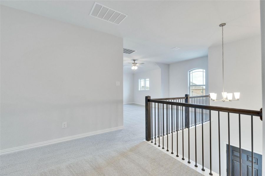 Hall featuring carpet and a chandelier Hall featuring carpet and a chandelier