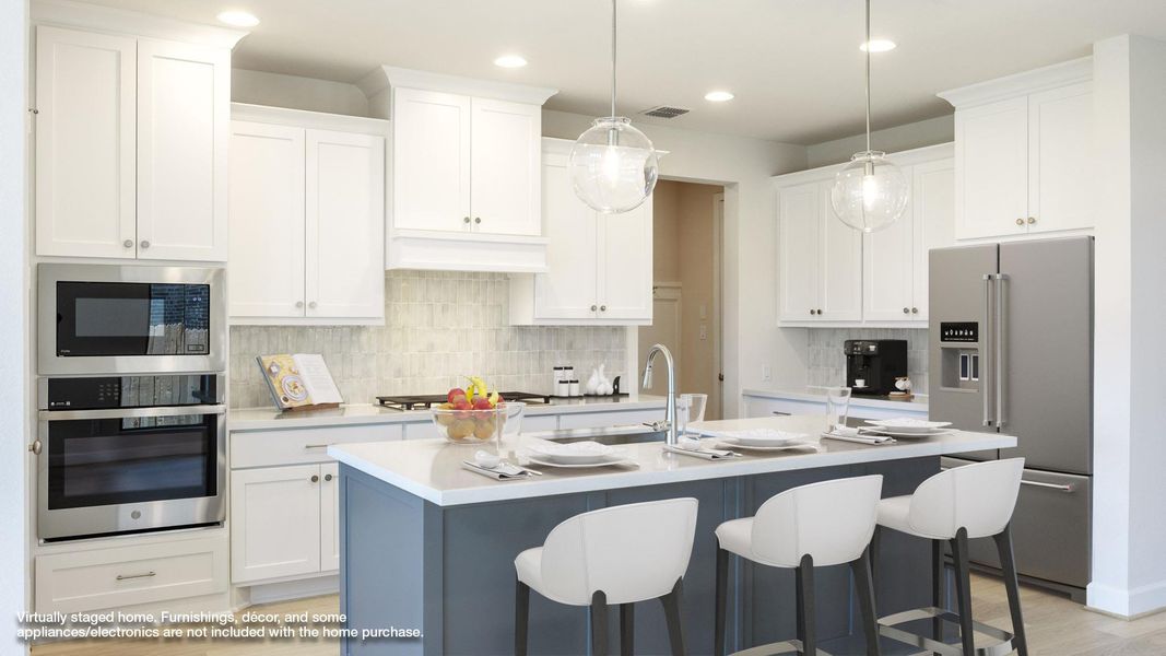 Kitchen with stainless steel appliances, decorative backsplash, a kitchen bar, white cabinetry, and recessed lighting