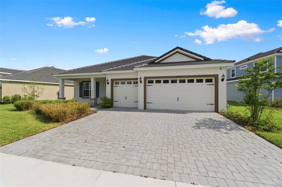 Front exterior of a new home in Tamarack at Two Rivers, Zephyrhills, FL, highlighting curb appeal (Image 26).