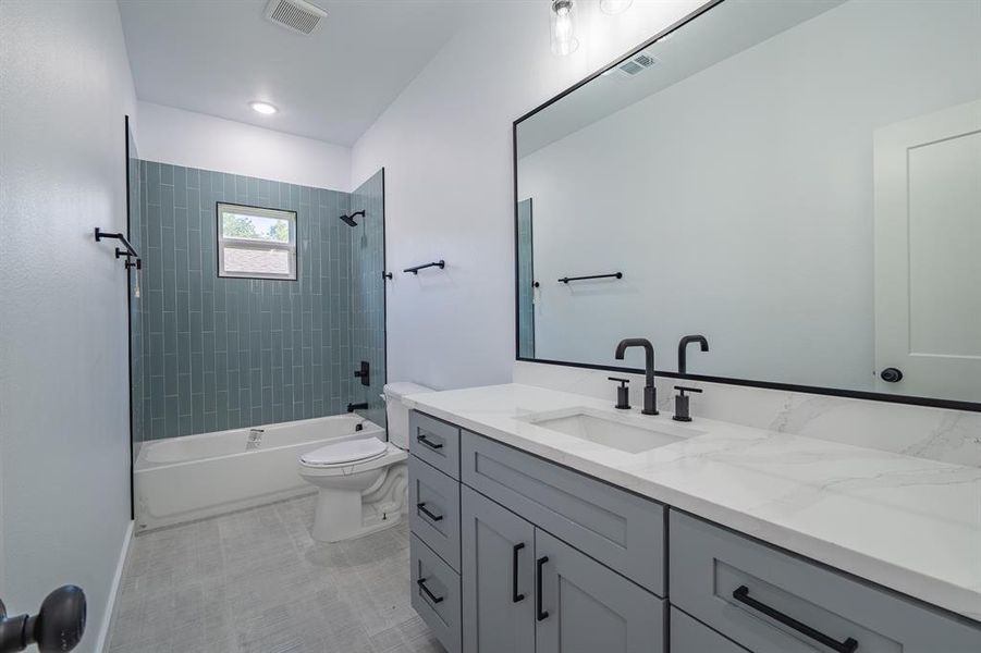 Bathroom featuring vanity and tub / shower combination Bathroom featuring vanity and tub / shower combination
