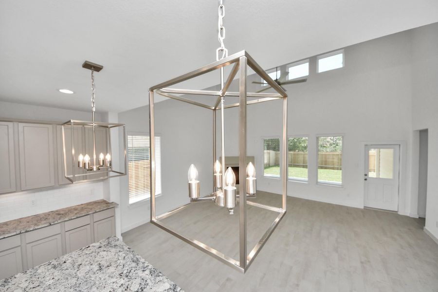 All of this overlooks your expansive family room, creating a perfect space for culinary delights and family gatherings. Sample photo of completed home with similar floor plan. Actual colors and selections may vary.
