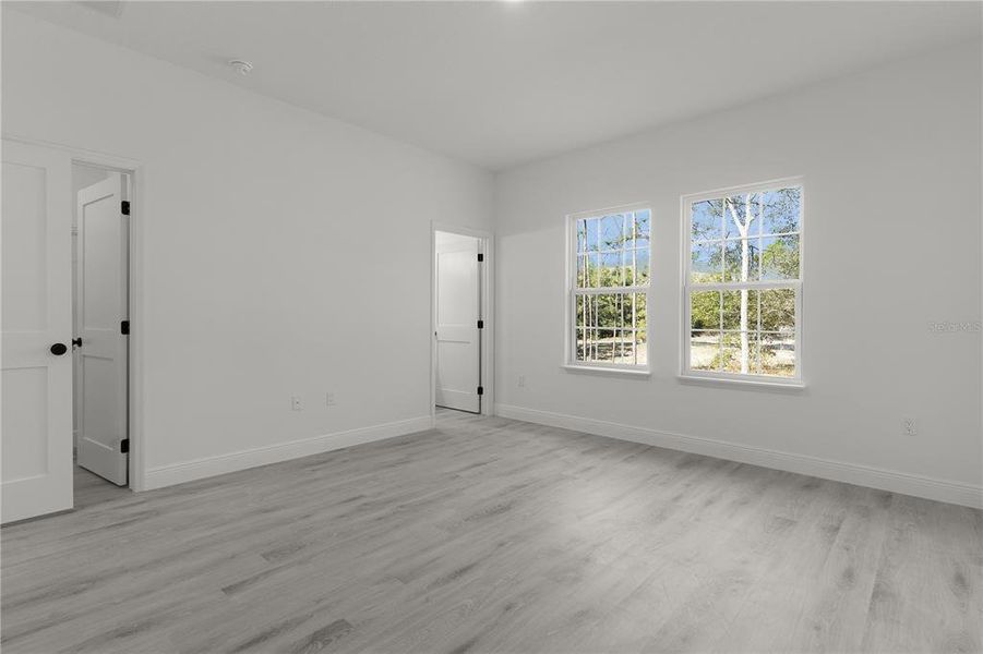 Primary bedroom with walk-in closet and ensuite bathroom