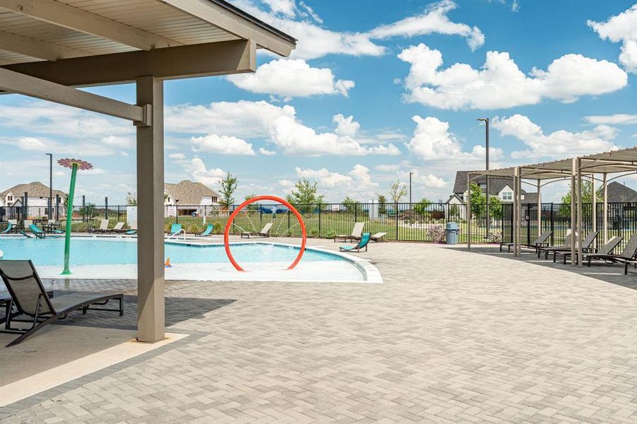 View of pool with a patio area and pool water feature