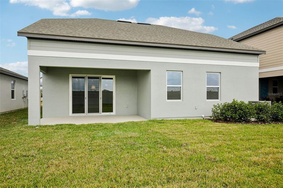 Exterior details and patio area of a home in Oakfield Trails, Parrish (Image 12).