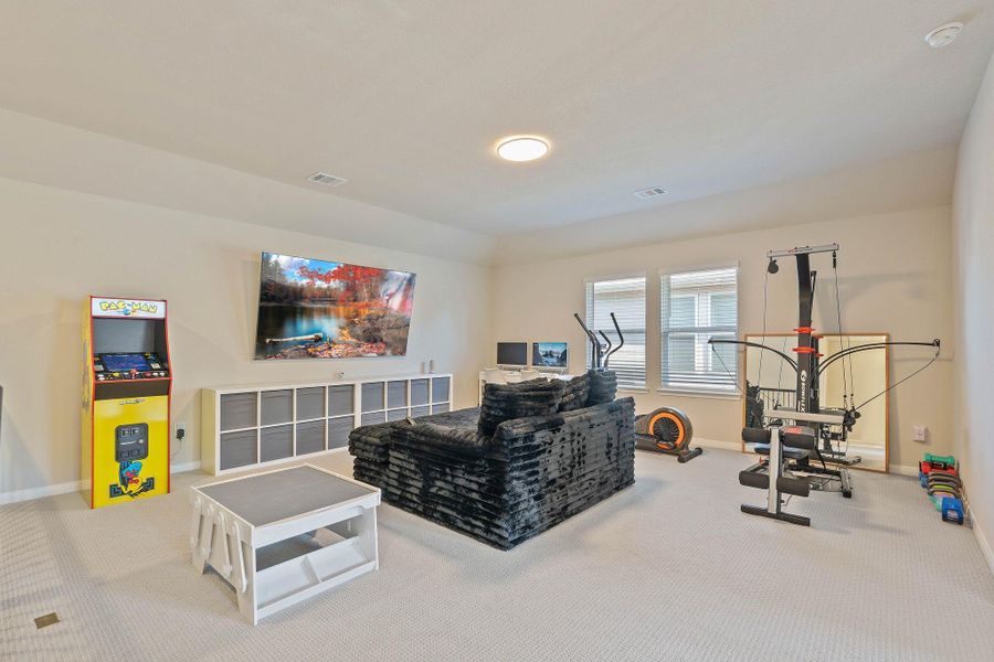 This spacious and bright game room features ample natural light and upgraded carpeting perfect for entertainment. This spacious and bright game room features ample natural light and upgraded carpeting perfect for entertainment.