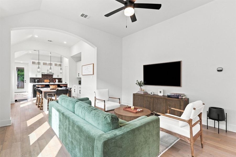 Hardwood floors and vaulted ceilings anchor this modern open floor plan.