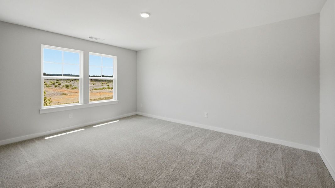 Spacious secondary bathroom with carpet and windows