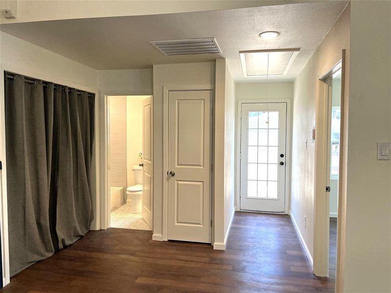 Interior hallway featuring wood-finish flooring