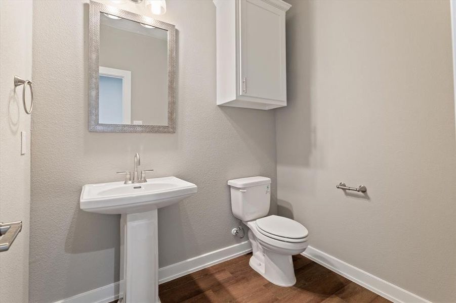 Bathroom featuring hardwood / wood-style floors and toilet Bathroom featuring hardwood / wood-style floors and toilet