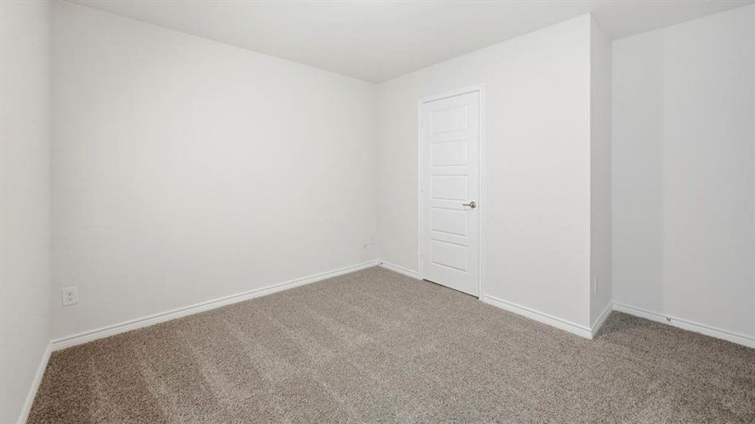 Carpeted empty room with baseboards