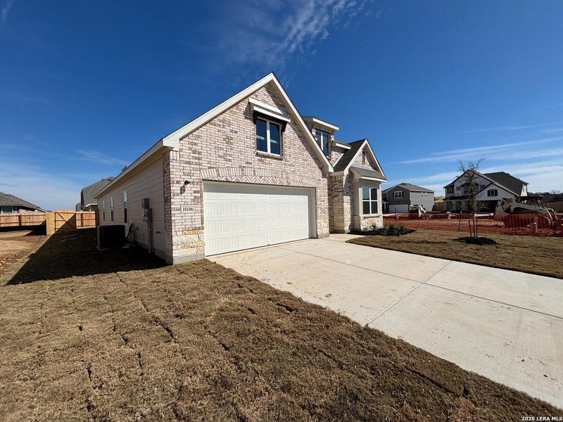 Front exterior of a new home in Saddlebrook Ranch, Schertz, TX, highlighting curb appeal (Image 18). Front exterior of a new home in Saddlebrook Ranch, Schertz, TX, highlighting curb appeal (Image 18).